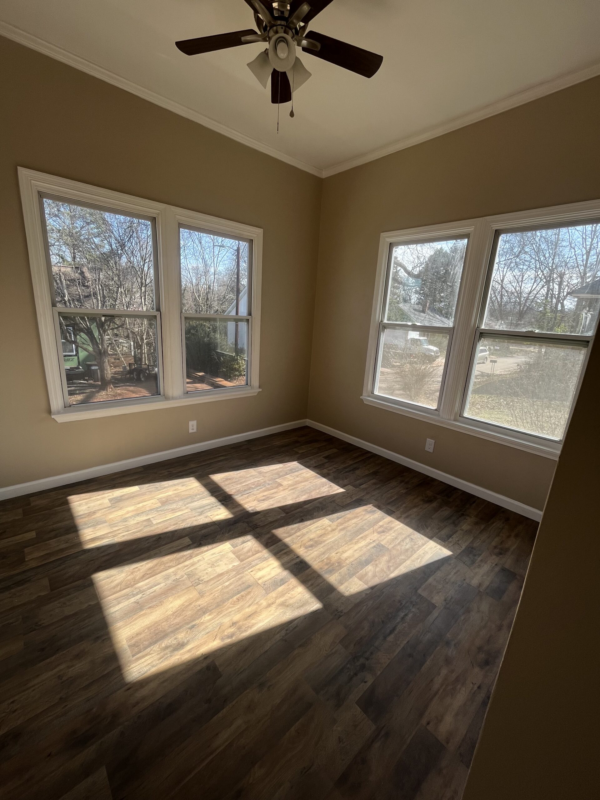 Room with new LVP flooring and two windows