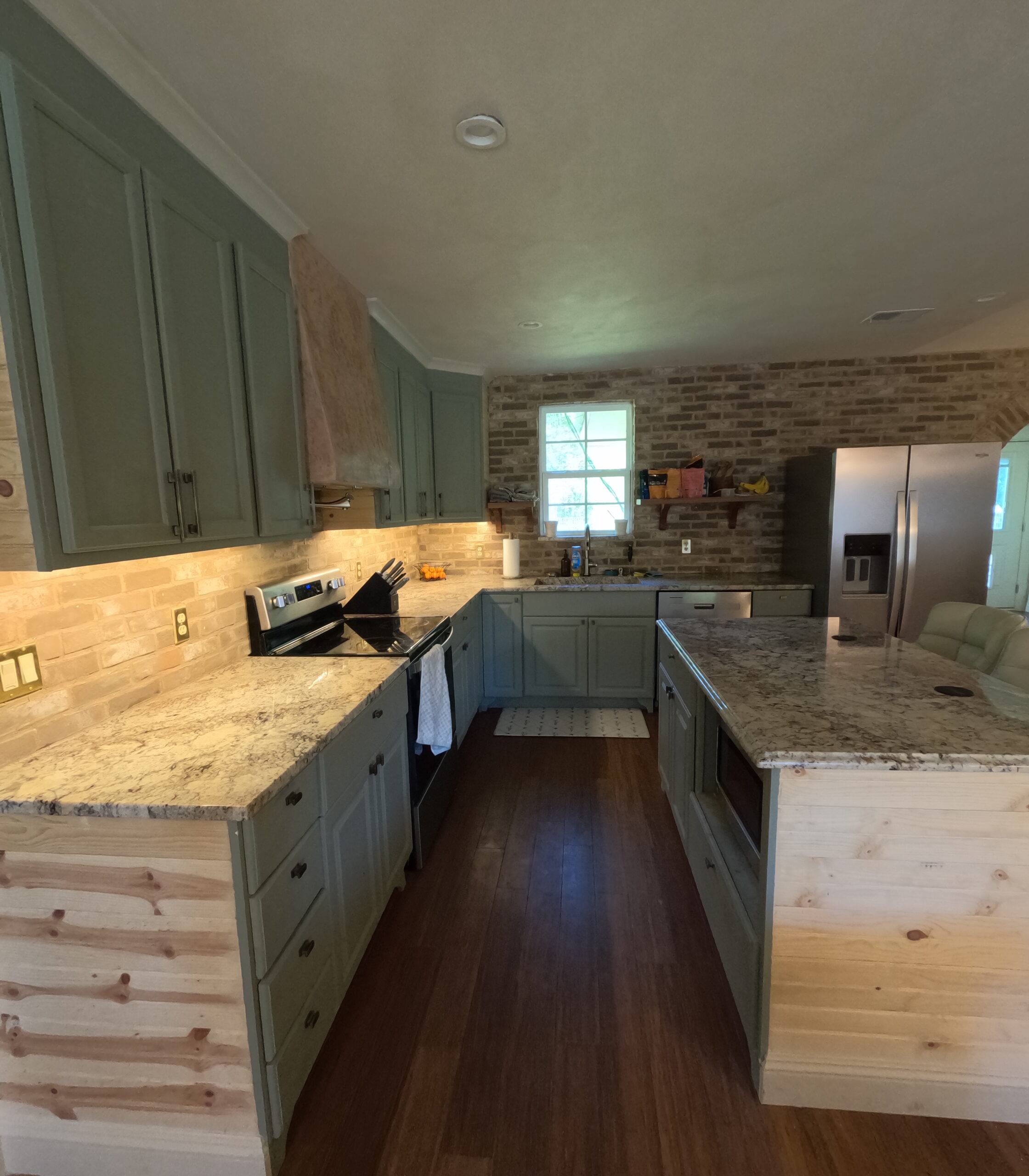 Kitchen with under-cabinet lighting Kitchen with under-cabinet lighting, granite counters and an exposed brick backsplash