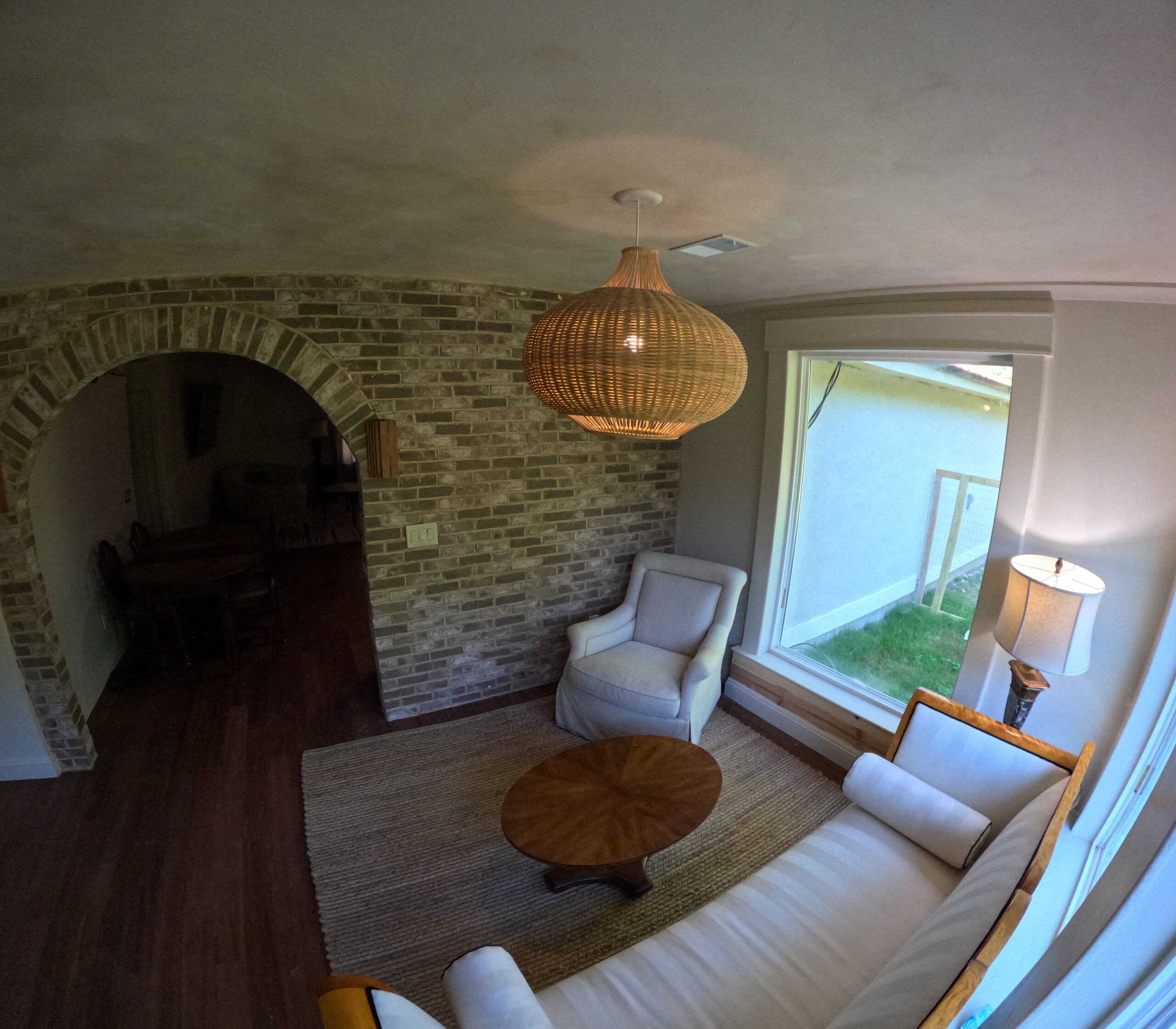 Sunroom facing an exposed brick wall Sunroom facing an exposed brick wall, with a woven pendant light