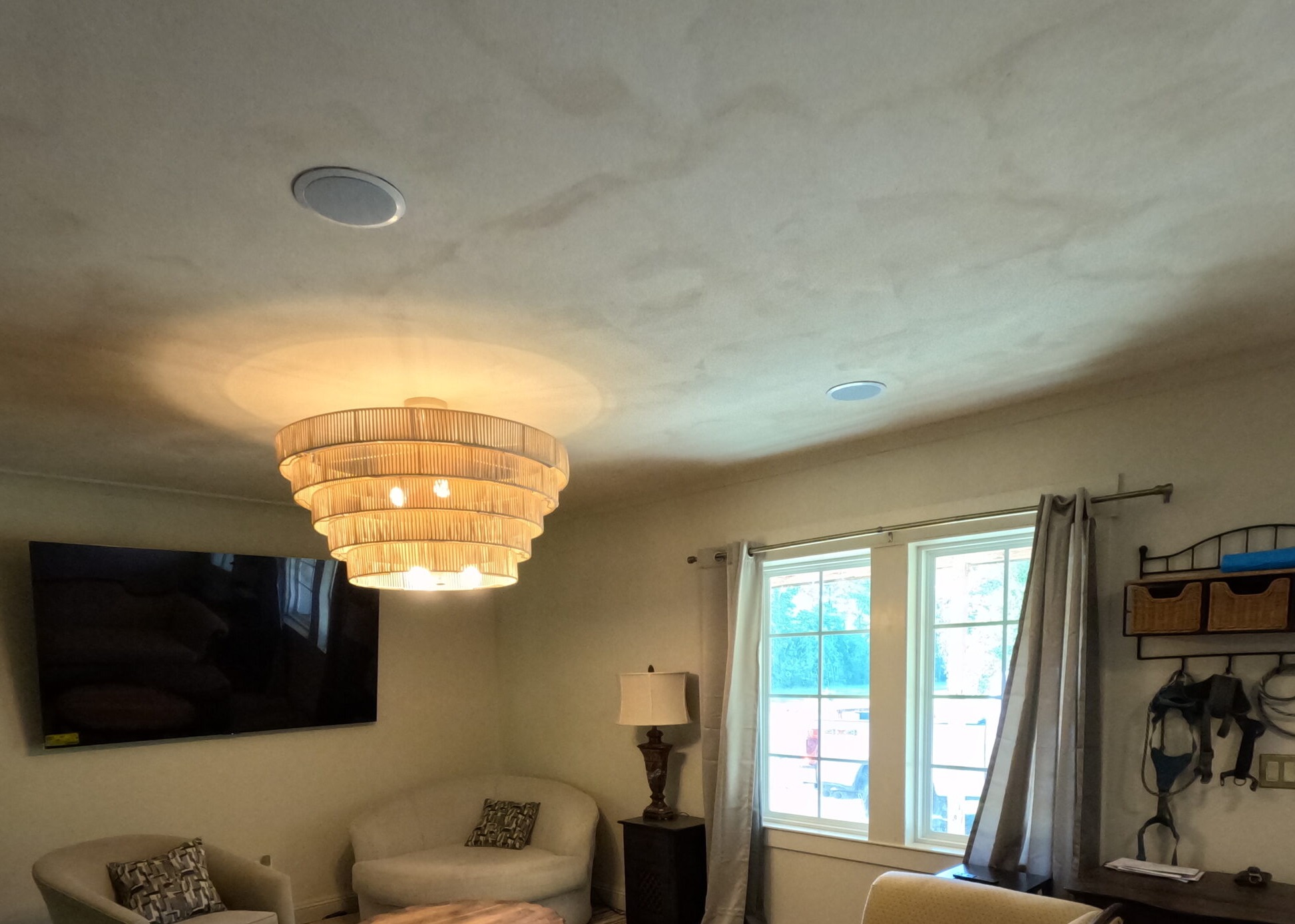 Limewash ceiling with a soft, mottled finish above a living room with a tiered pendant light