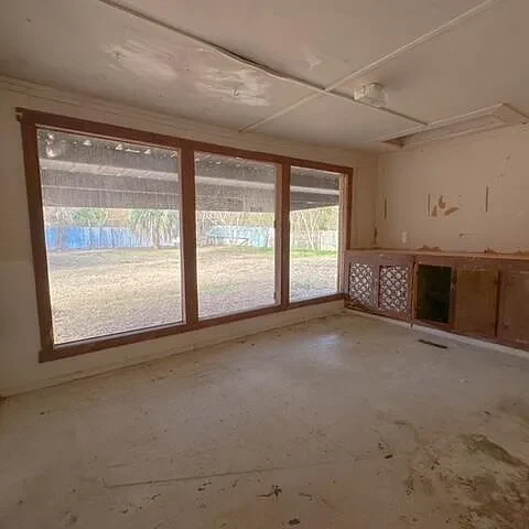 Before: the gutted room with a wall of windows
