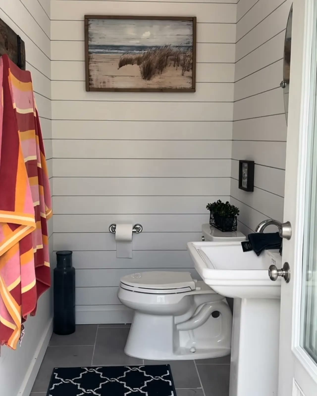Pool pavilion bathroom in shiplap Small bathroom finished in white shiplap with a pedestal sink and a grey tile floor