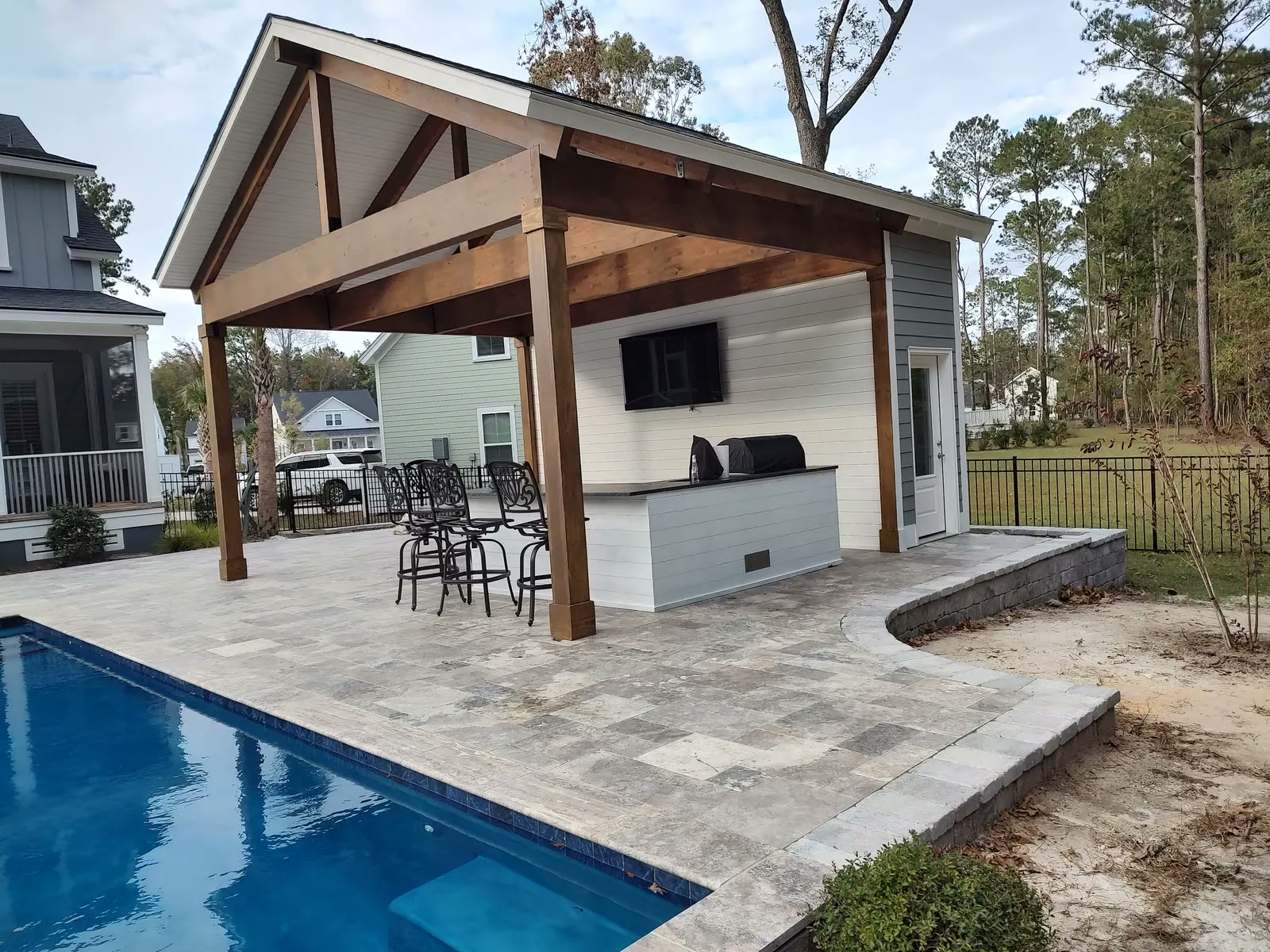Pool pavilion with exposed glulam beams Gabled pool pavilion with exposed glulam beams, cedar posts and a shiplap bar wall